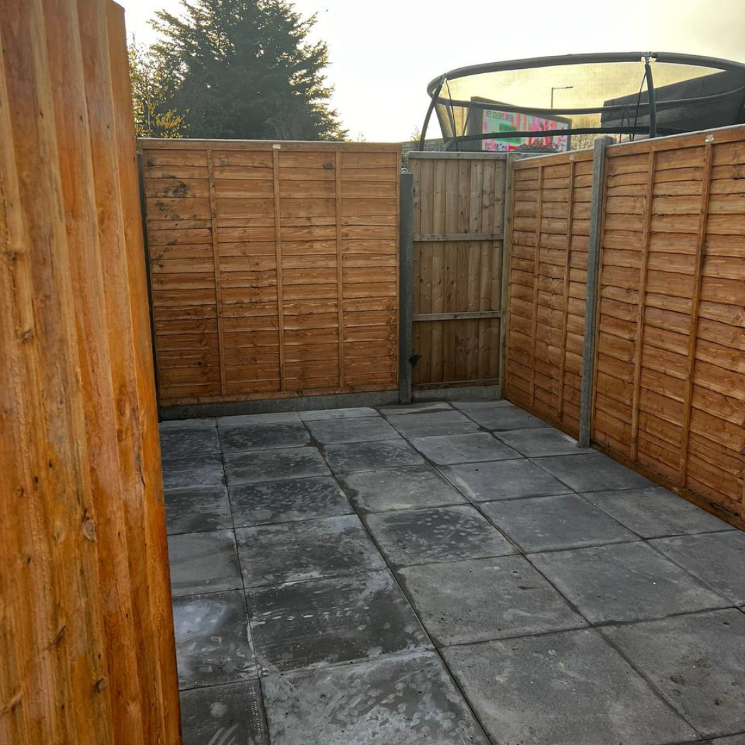 Mill Hill garden after — finished fencing, gate and fresh paving slabs