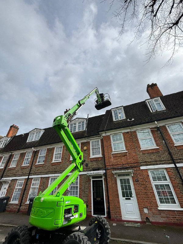 Cherry picker lift accessing high-level guttering on a period terrace in Islington