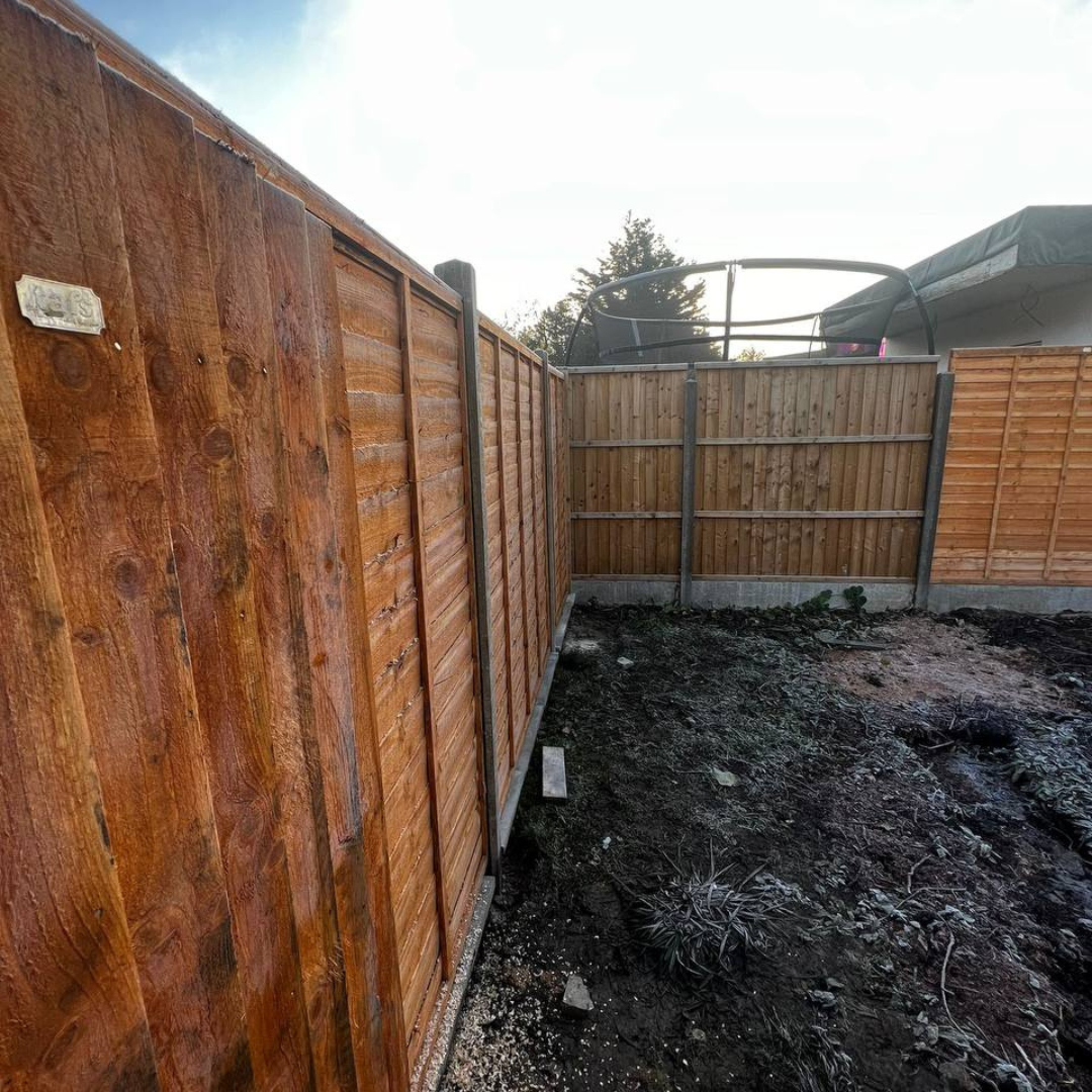 Mill Hill garden before — new fence panels installed on bare, uneven ground