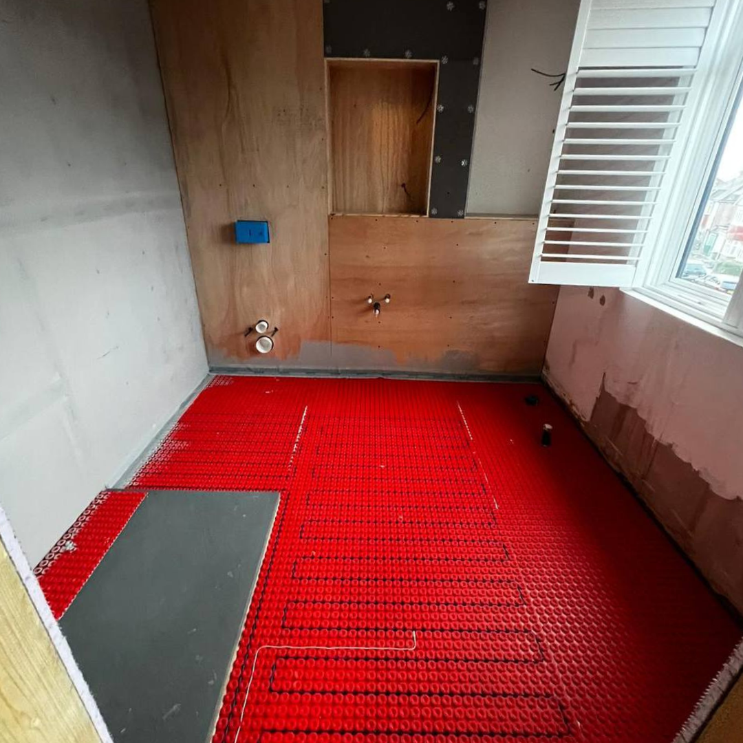 Barnet bathroom before — stripped back with new underfloor heating matting laid